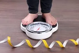 A Person checking the body weight 