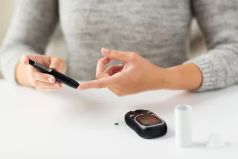 A woman checking her blood glucose level