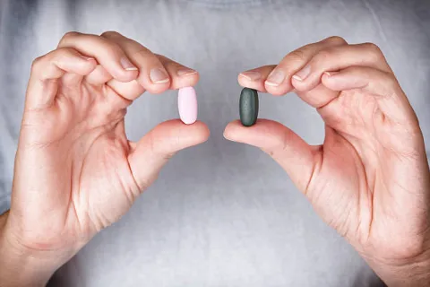 A person holding pills 