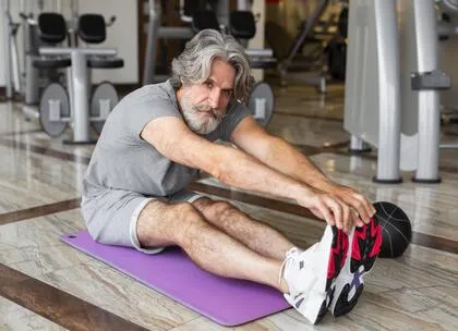 An old man is doing indoor exercise